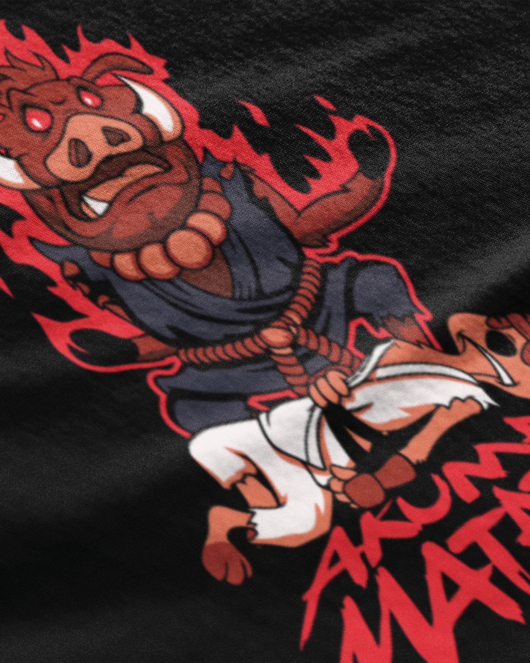 Close-up of Akuma Matata graphic t-shirt with cartoon fighter character and bold red lettering on black fabric