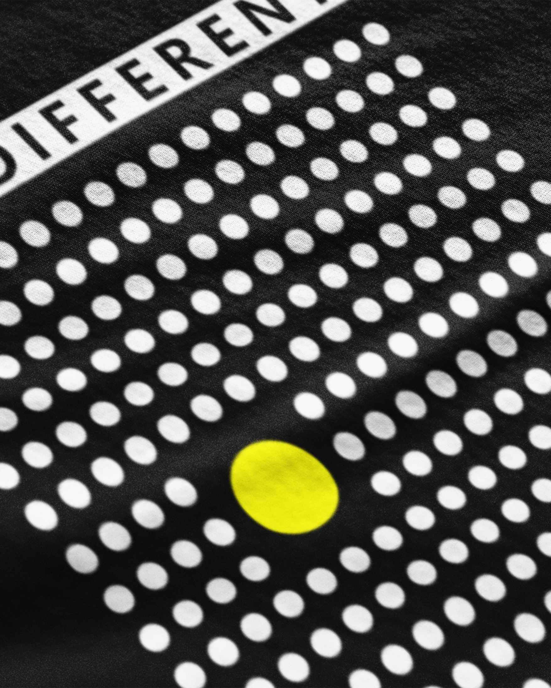 Close-up of METRO ALIEN casual wear t shirt for men with white dots and one yellow dot design on black fabric