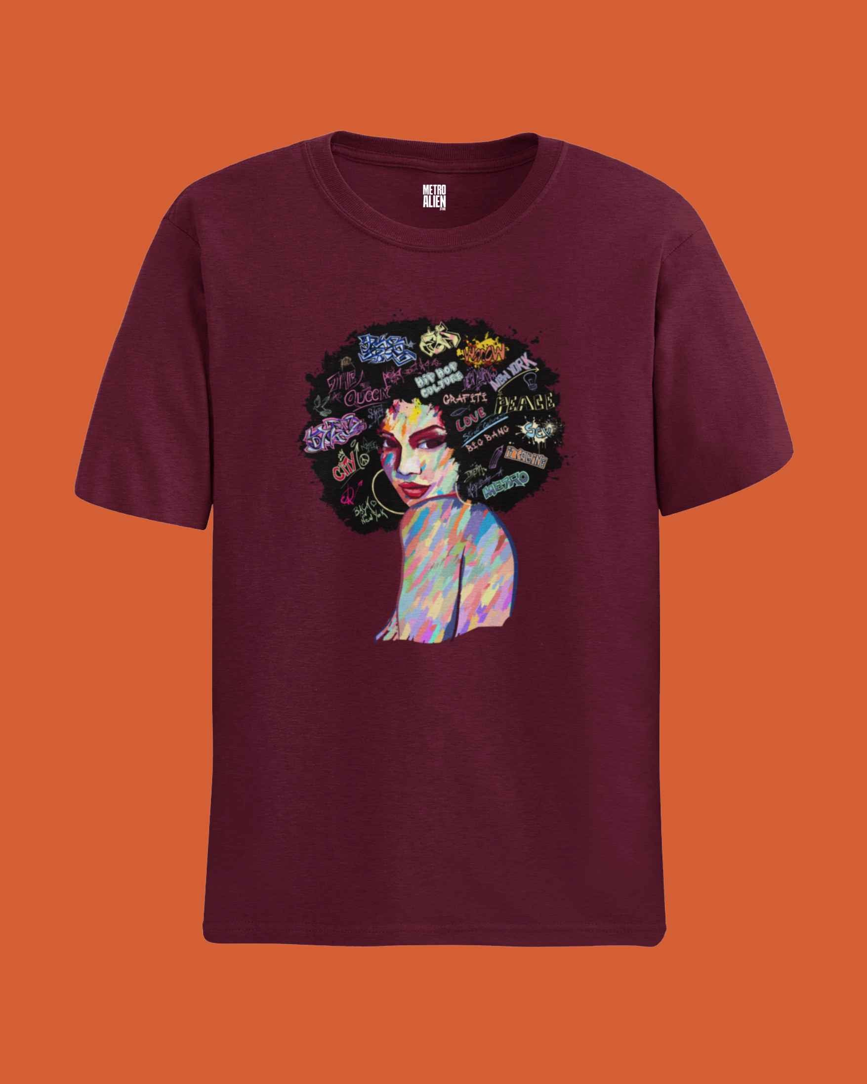 Maroon Afro art graphic t-shirt featuring colorful illustrated woman with afro hairstyle and words in hair