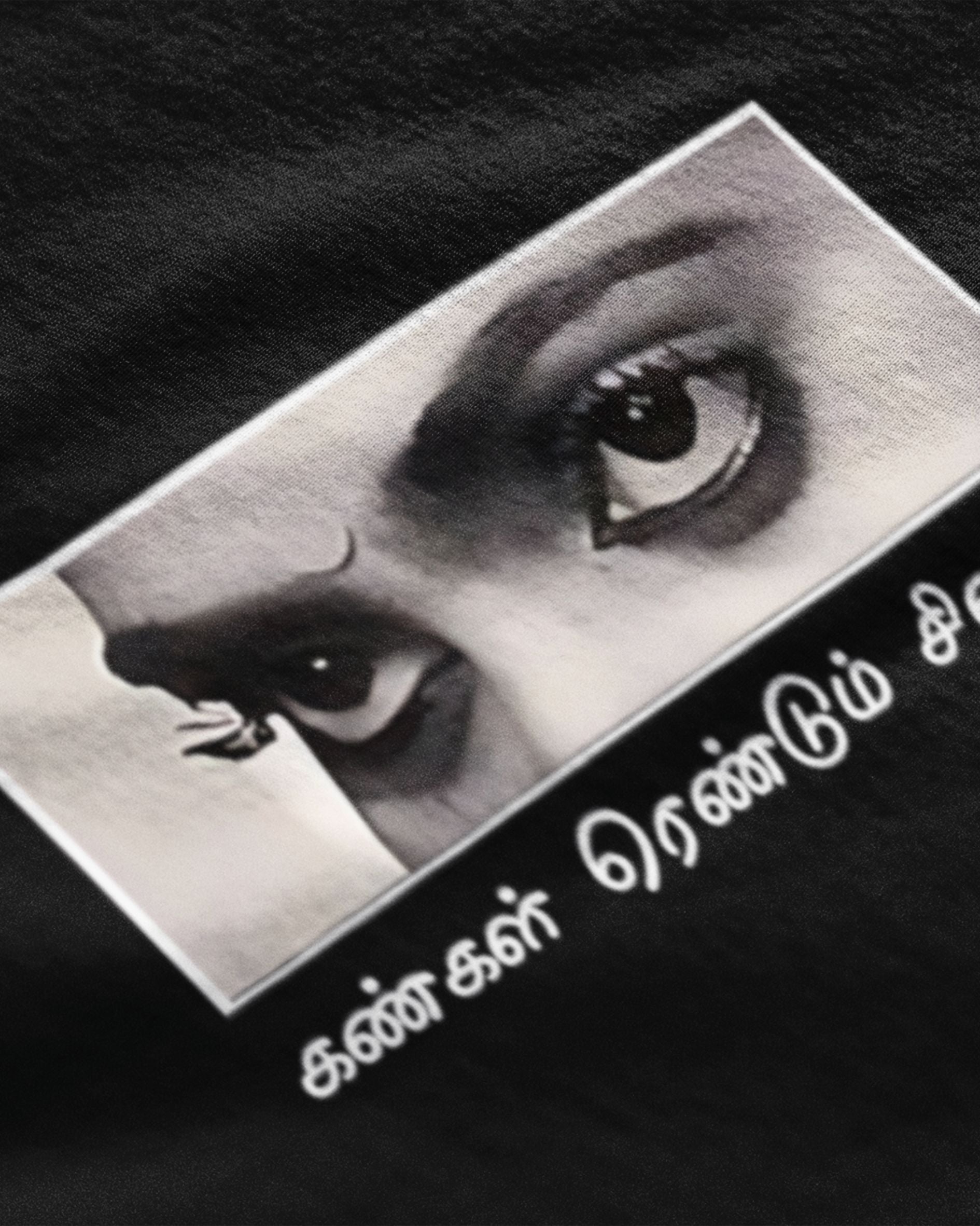 Close-up of black tamil cinema graphic t-shirt with intense eyes and Tamil script design by METRO ALIEN