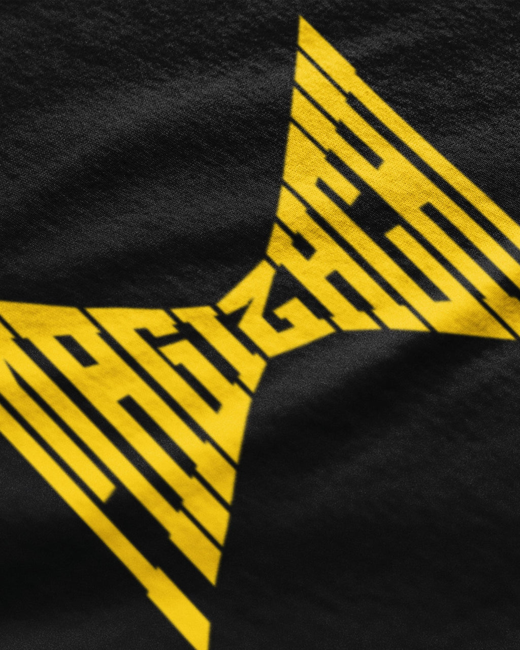 Close-up of black t-shirt with bold yellow graphic design from METRO ALIEN cool tamil graphic t-shirts online
